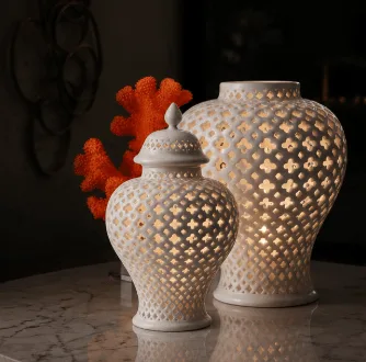Pierced porcelain lanterns glowing on a marble table